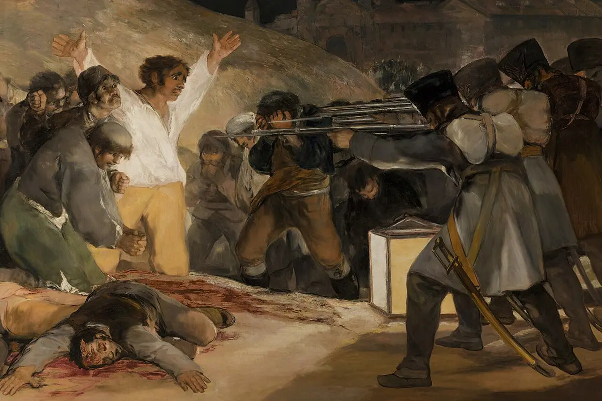 Goya painting of a French firing squad shooting Madrid civilians at night, a man in a white shirt raising his arms