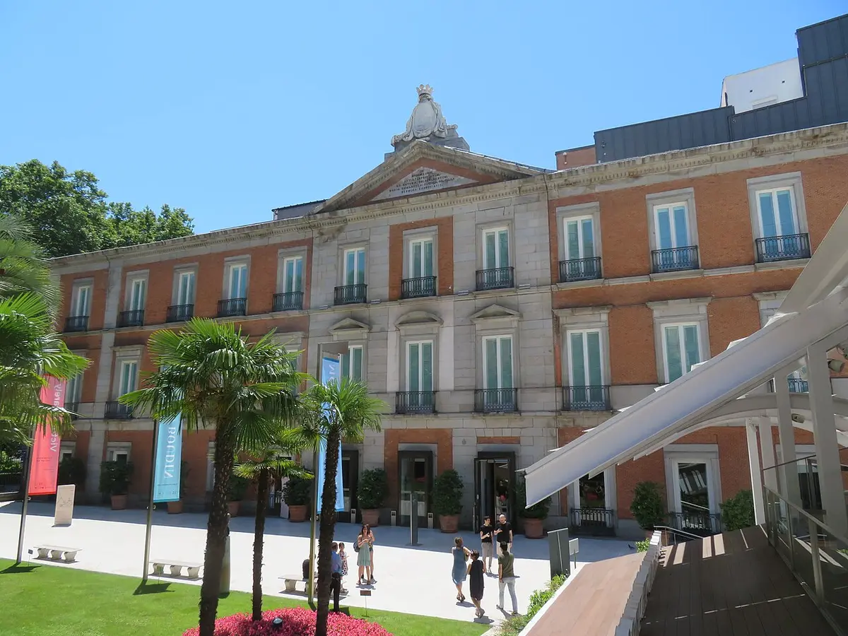 The Villahermosa Palace, home of the Thyssen-Bornemisza Museum, seen from its garden with palm trees