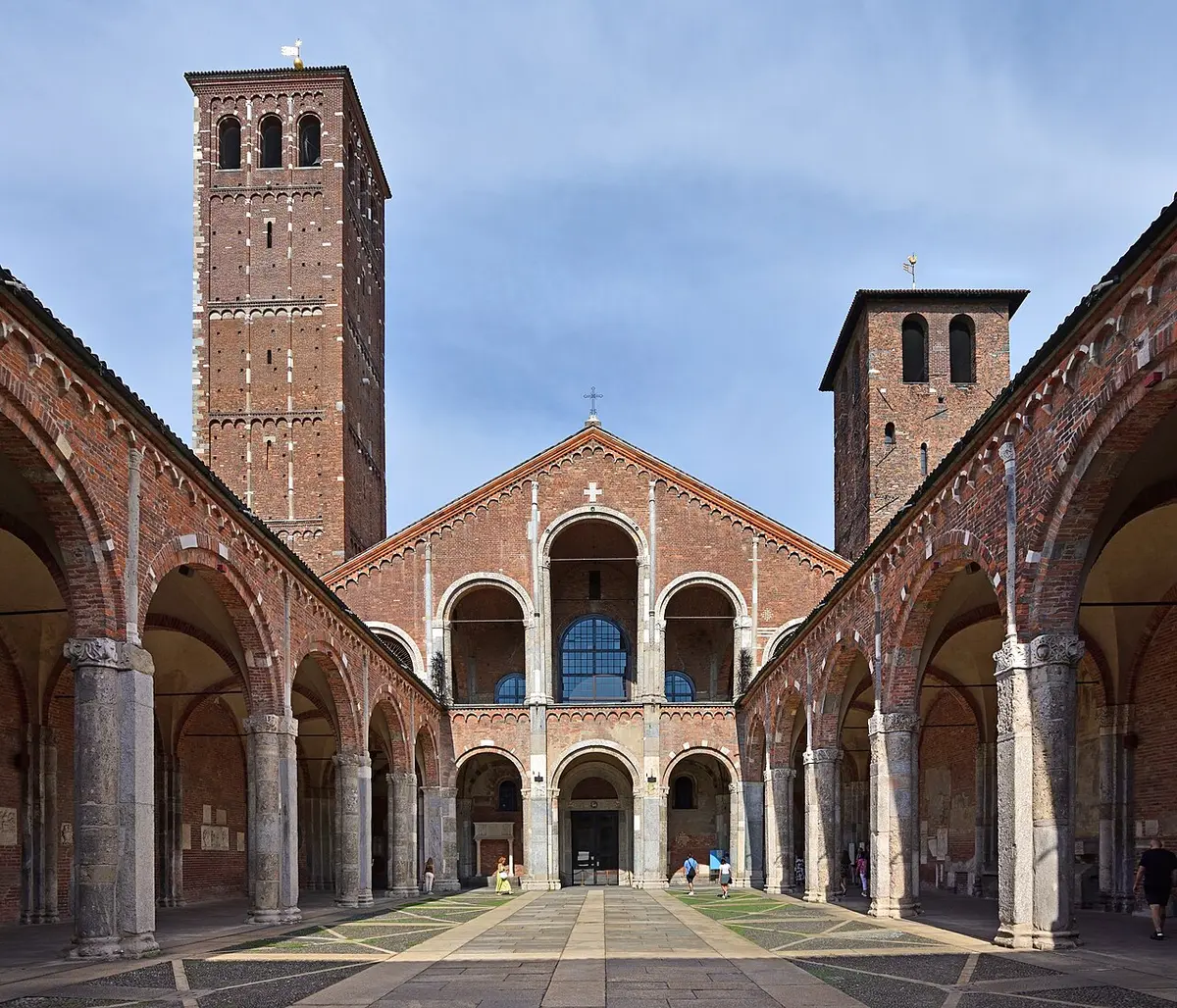 The brick atrium of Sant’Ambrogio, its arcades leading to the church front and two bell towers