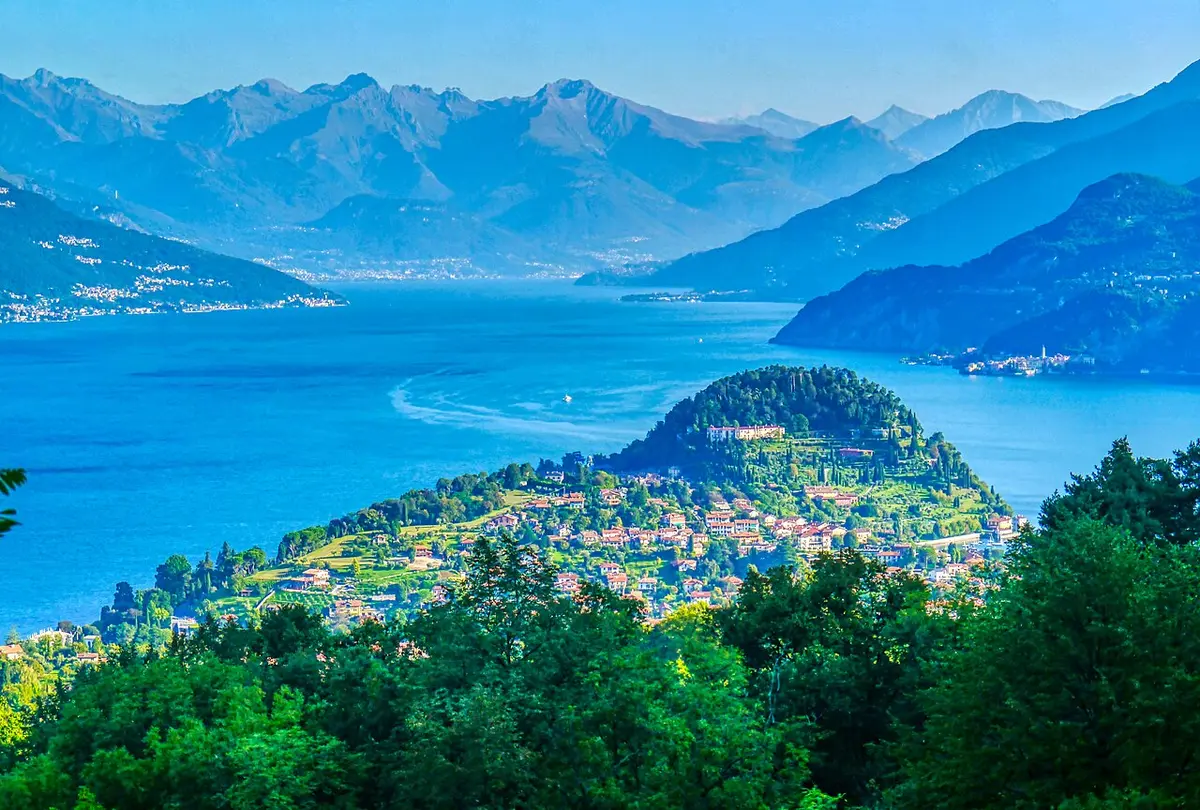 The wooded promontory of Bellagio where Lake Como divides, mountains beyond