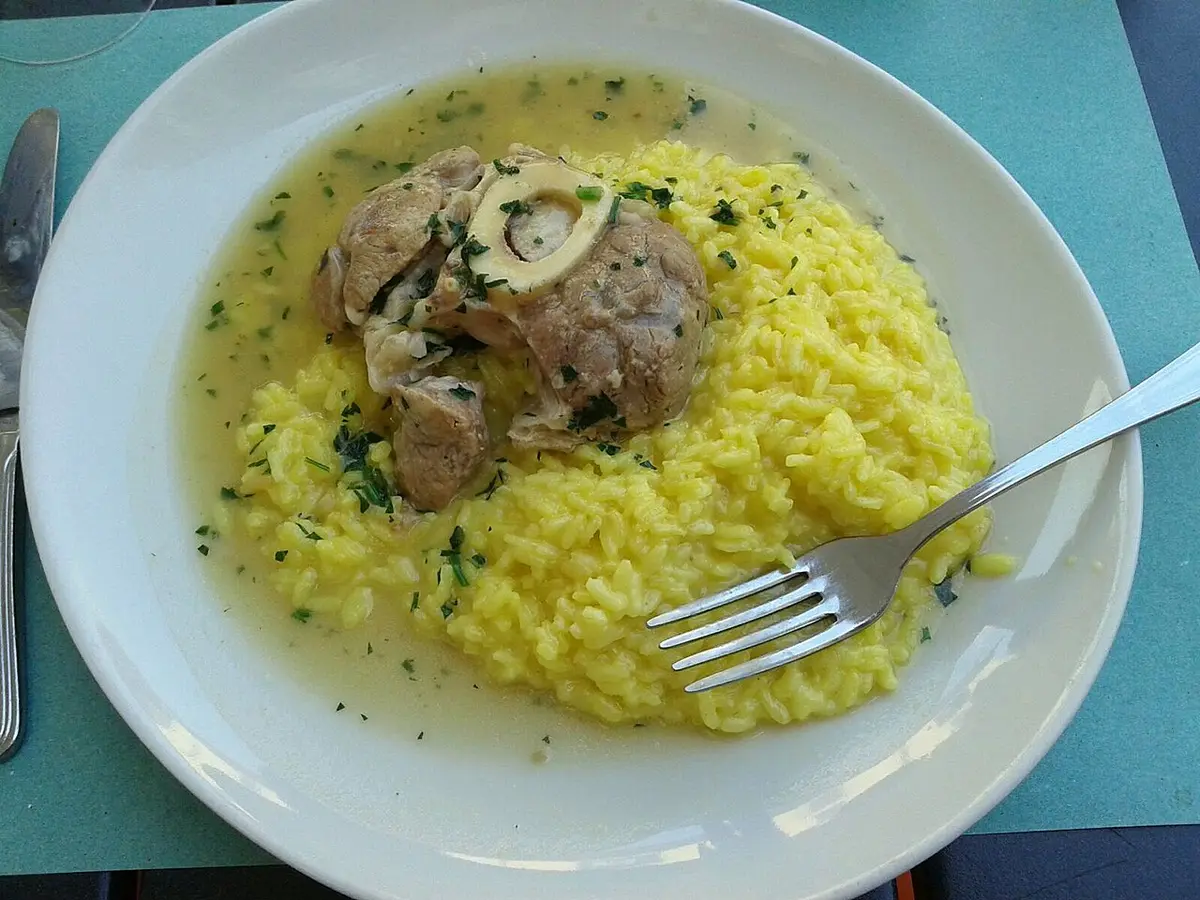 Ossobuco, a braised veal shank with its marrow bone, on a bed of saffron risotto