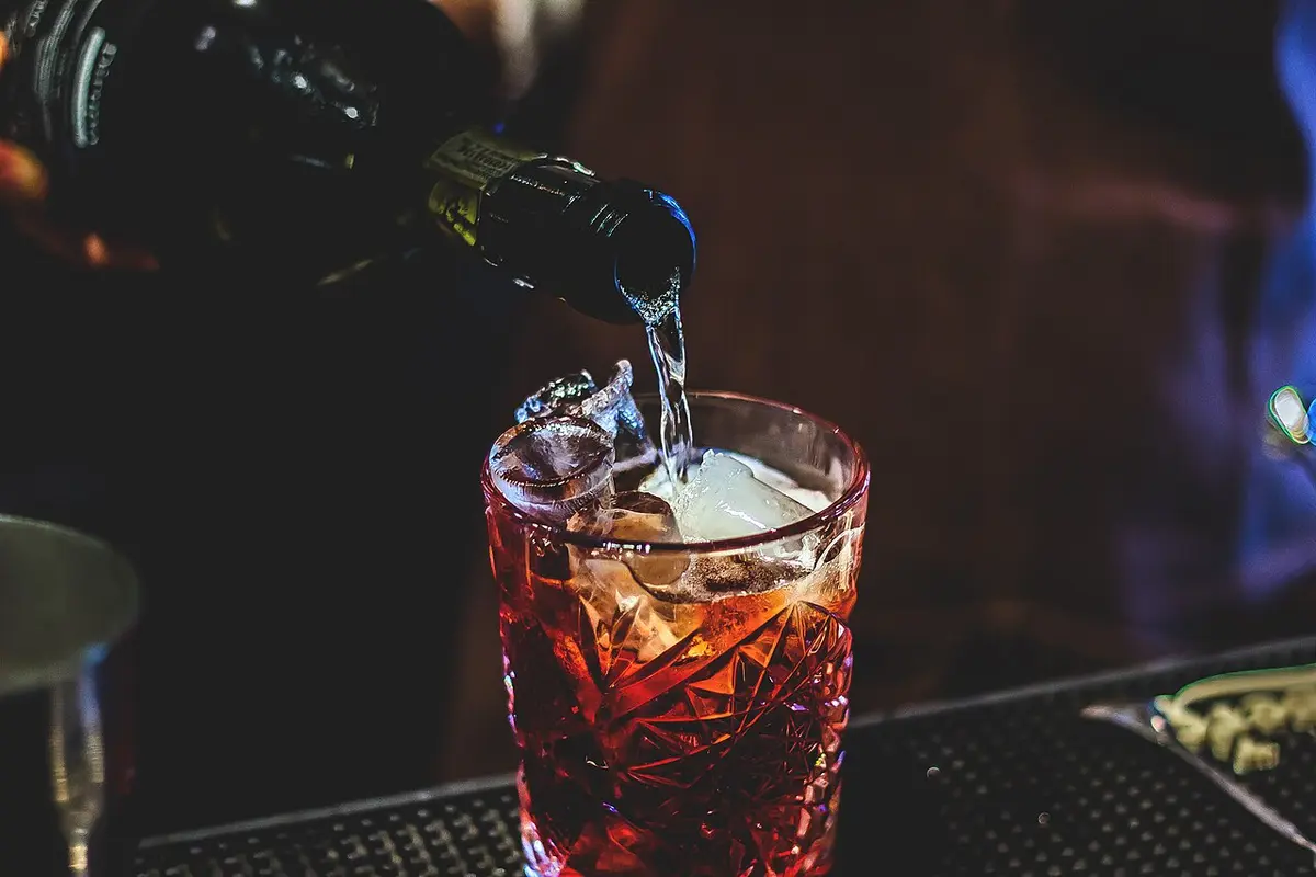 Sparkling wine poured over ice into a cut-glass tumbler of red Negroni sbagliato