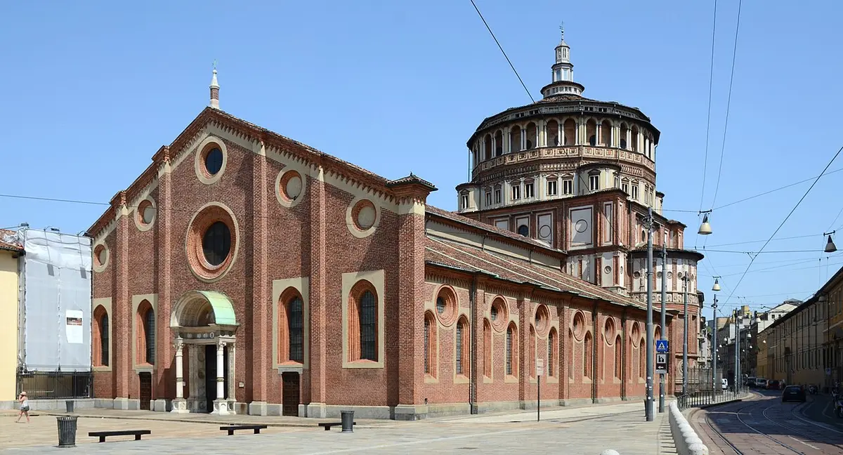 The brick church of Santa Maria delle Grazie, with round windows and Bramante’s domed tribune