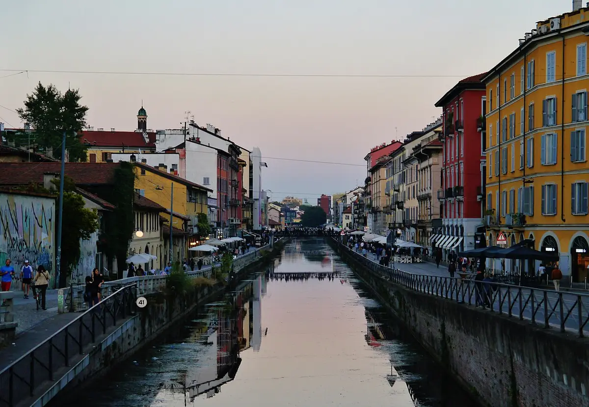 The Naviglio Grande at dusk, with colored houses and café terraces on both banks