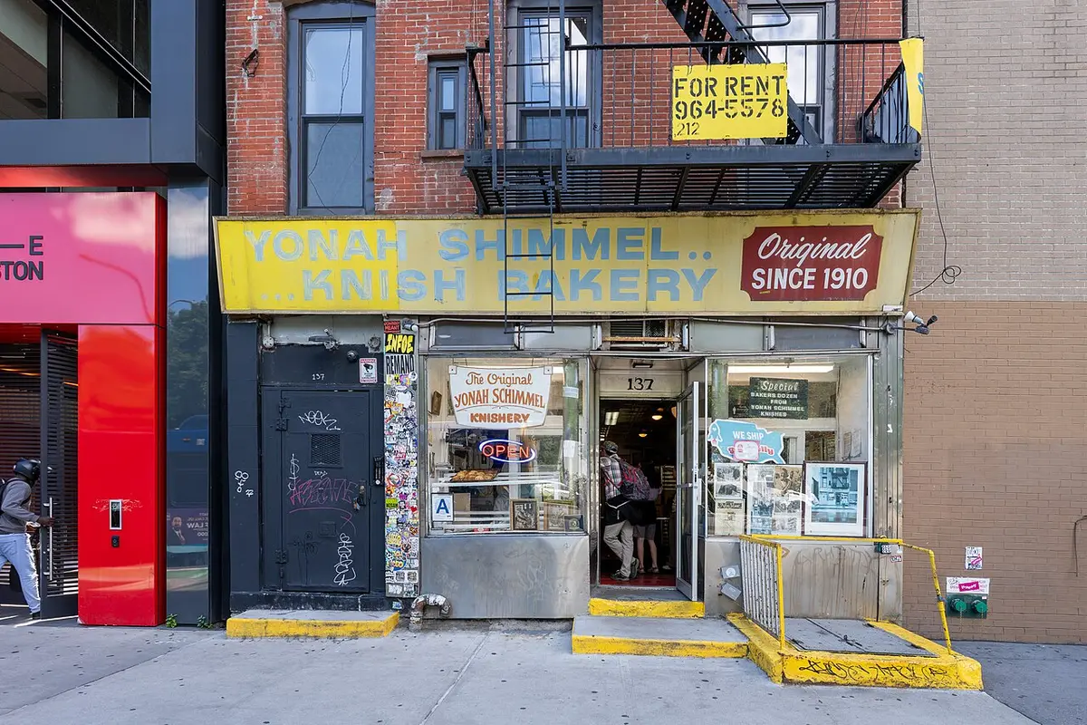 The yellow sign and shopfront of Yonah Schimmel Knish Bakery on East Houston Street