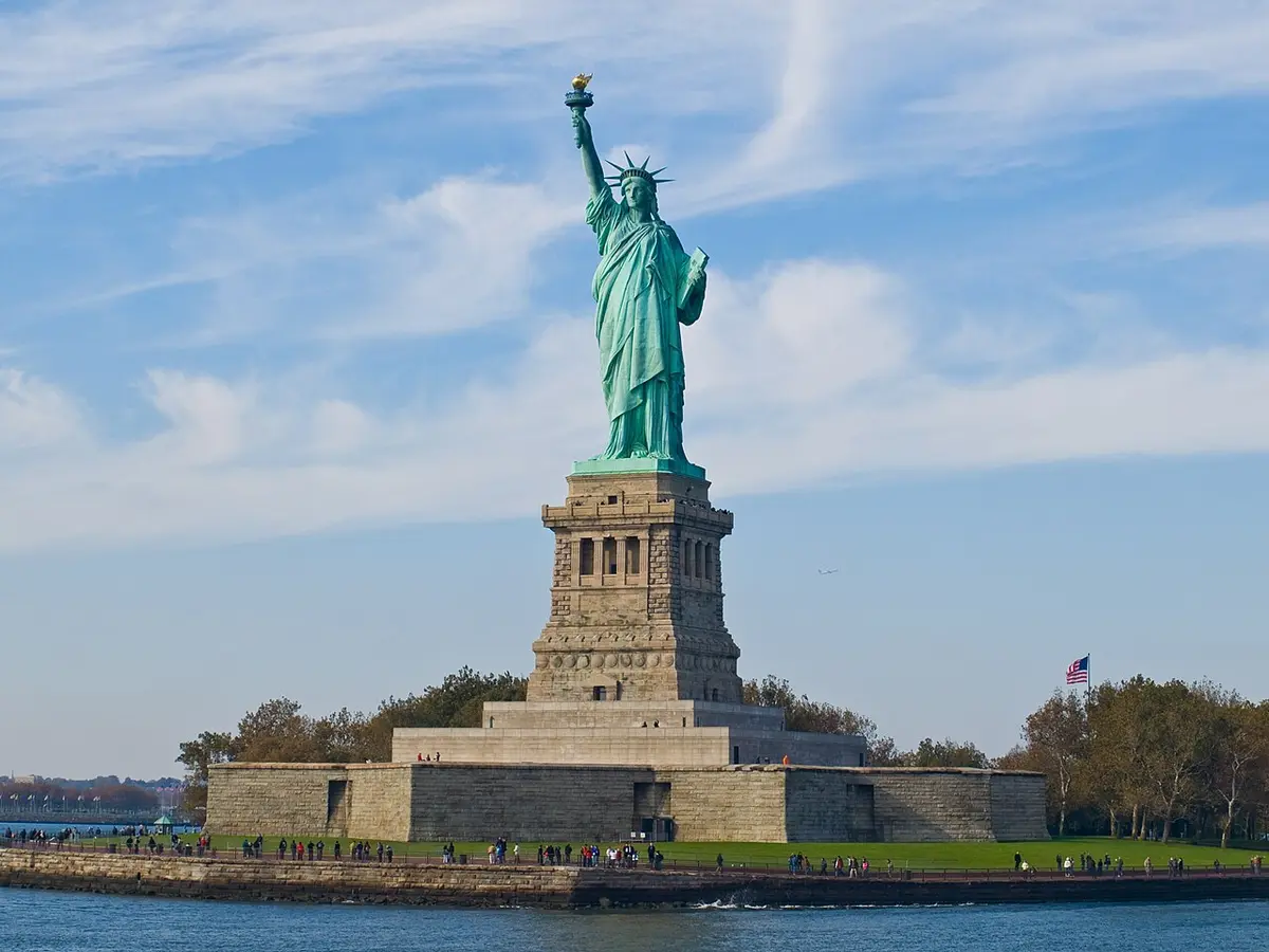 The Statue of Liberty on its pedestal on Liberty Island, seen from the water
