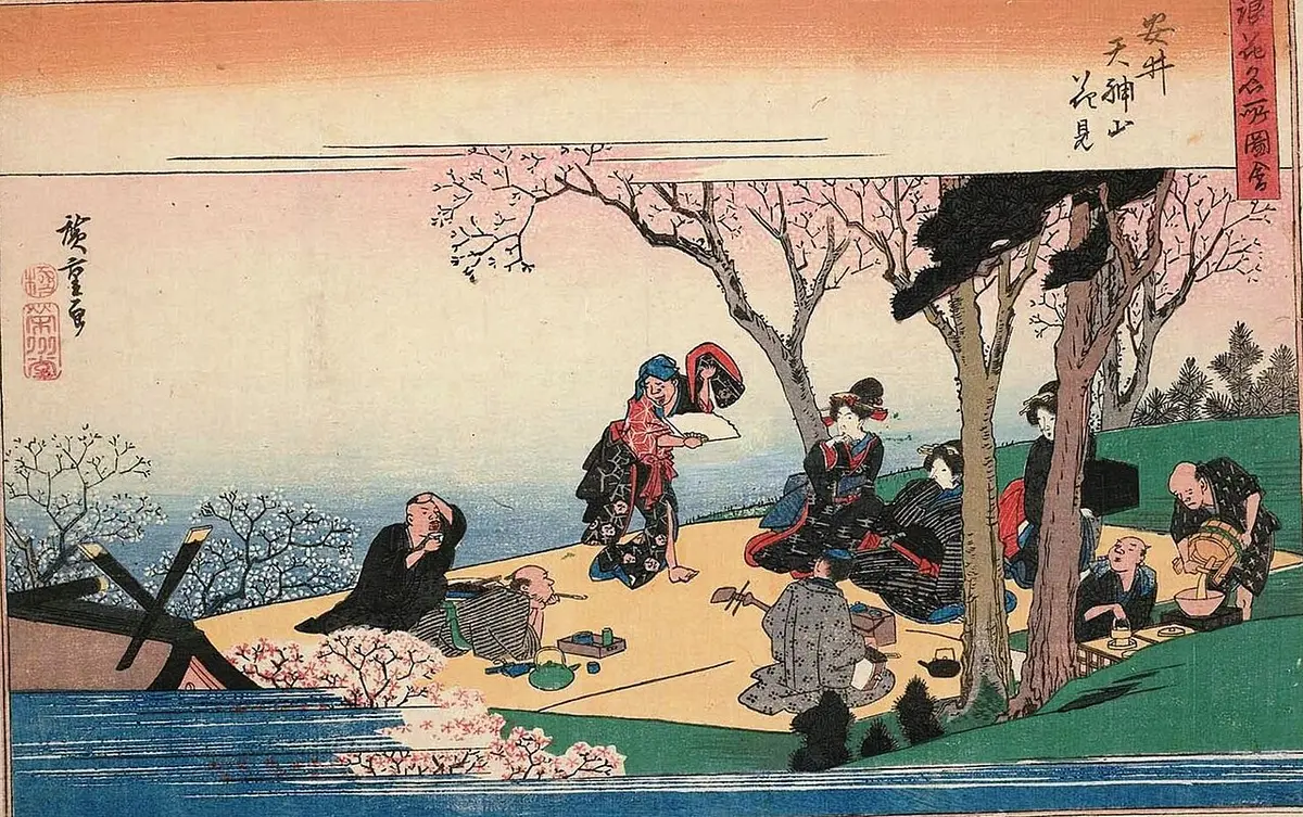 Hiroshige print of a picnic under blossoming cherry trees on a hill, with drinkers and a dancer
