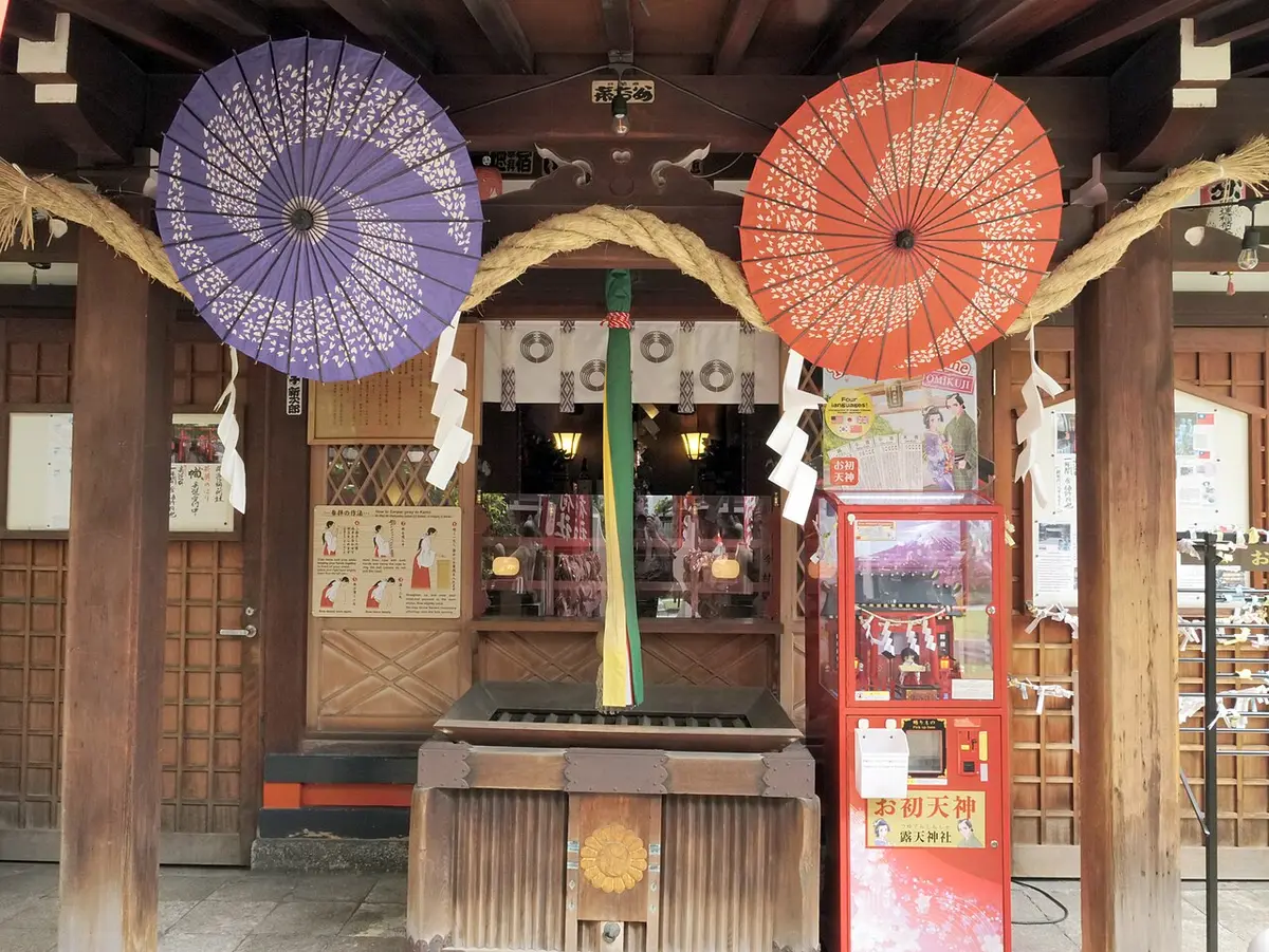 The worship hall of Ohatsu Tenjin, hung with paper parasols and a sacred rope