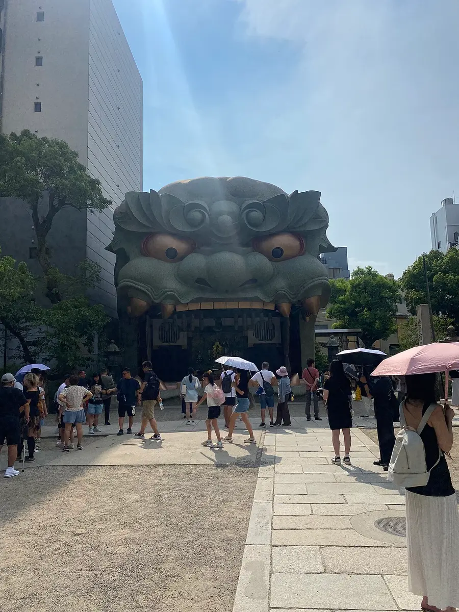 The giant lion head stage of Namba Yasaka Shrine with visitors in front