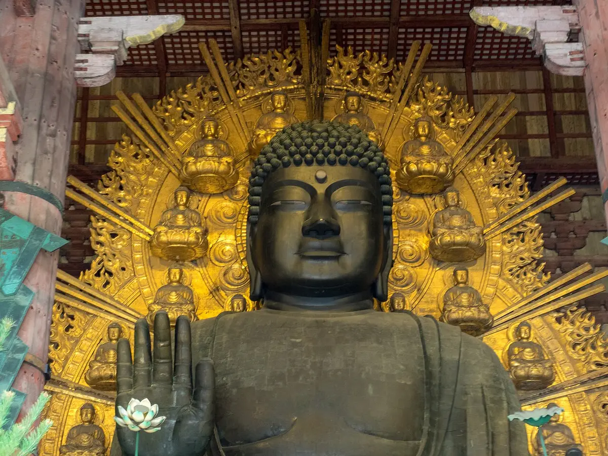 The bronze head of the Great Buddha of Tōdai-ji in front of a gilded halo