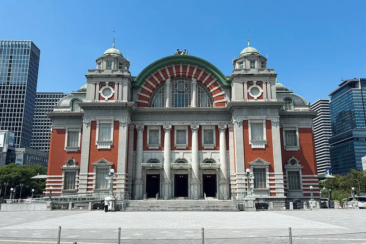 The red brick and white stone front of the Osaka City Central Public Hall under a blue sky