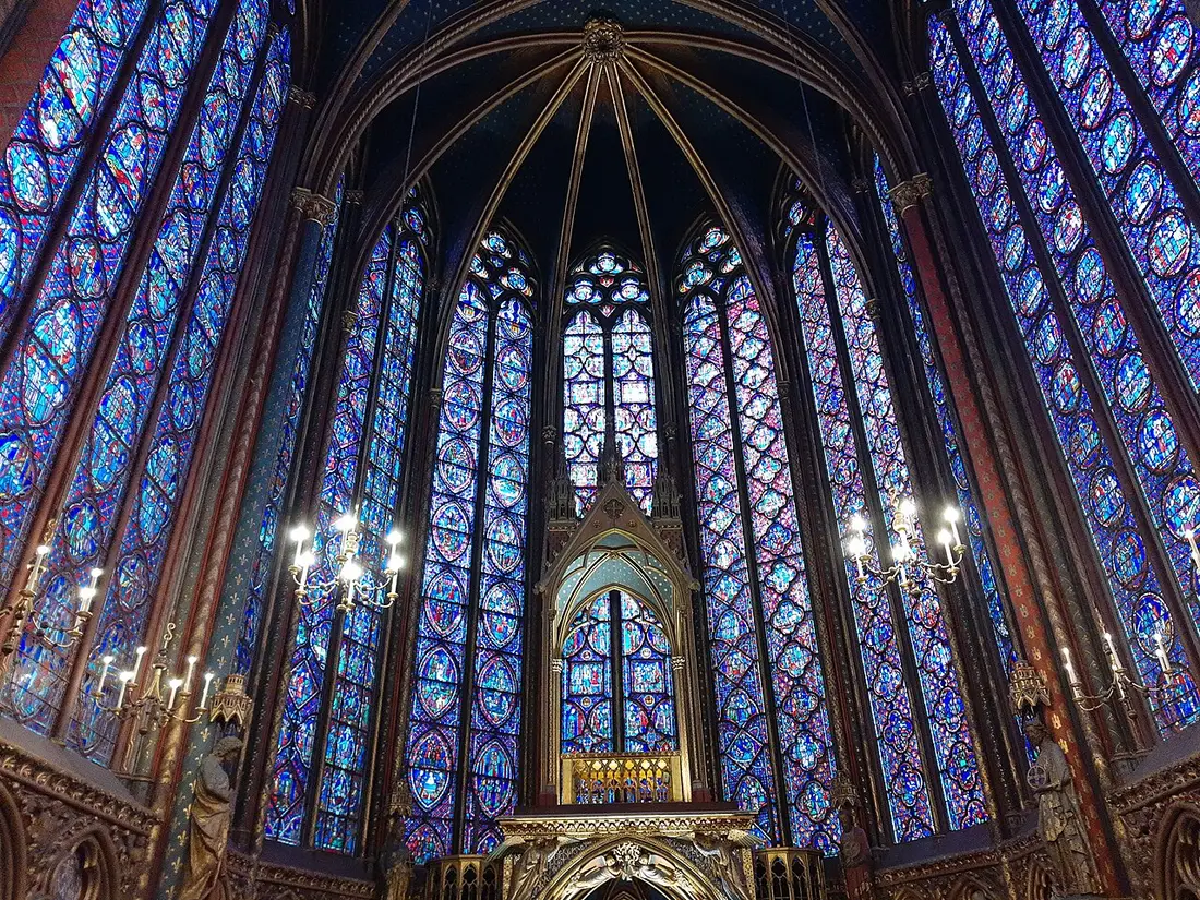 The tall blue and red stained-glass windows of the upper chapel of Sainte-Chapelle