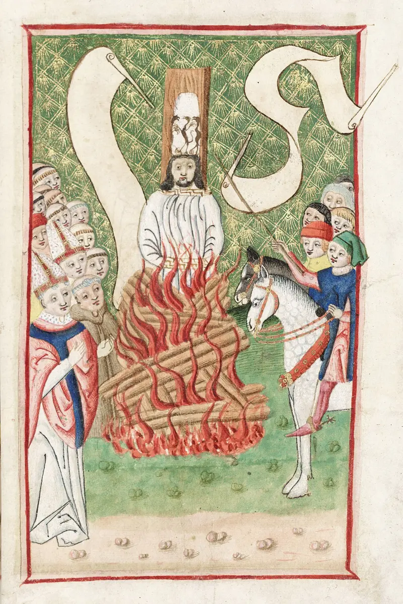 Medieval illumination of Jan Hus burning at the stake in a tall paper hat painted with devils, churchmen and a rider looking on