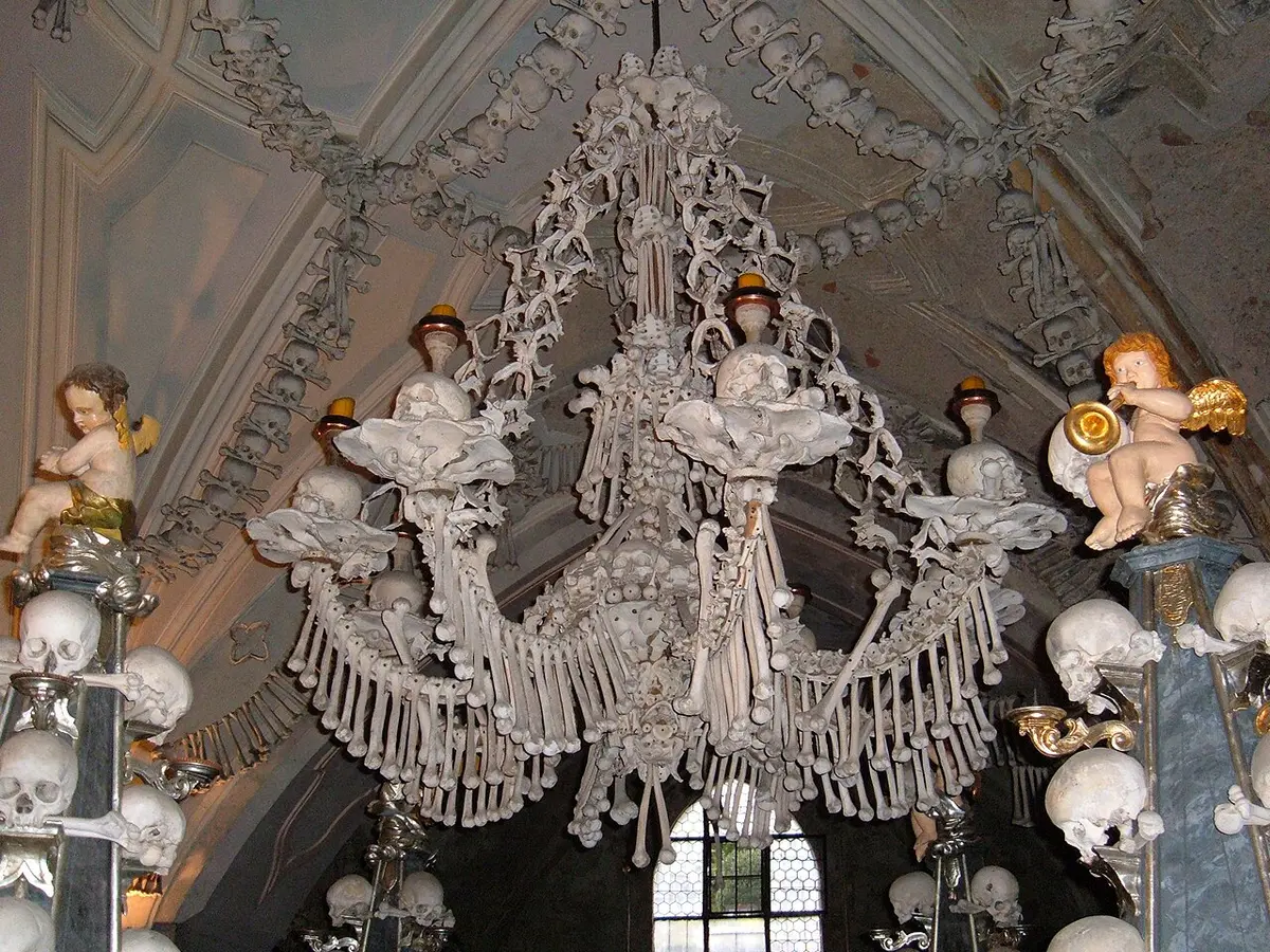 A chandelier made of human bones in the Sedlec Ossuary, with garlands of skulls on the vault