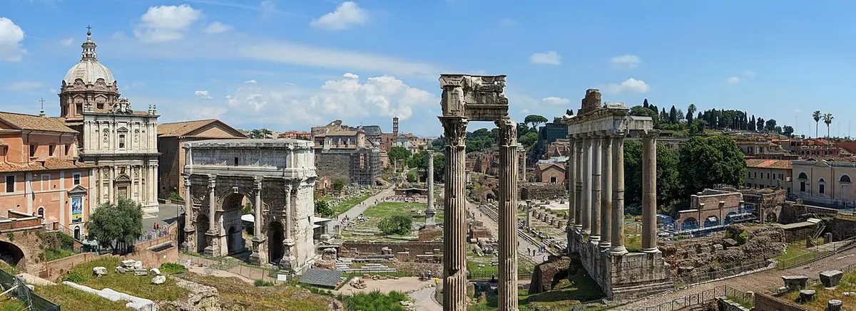The Roman Forum under a blue sky, with the columns of its temples in front