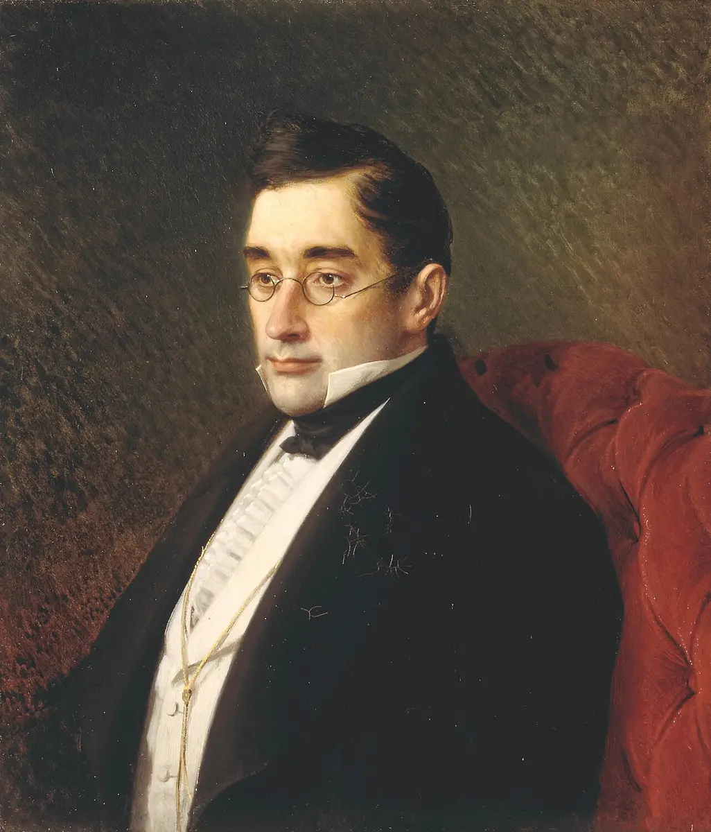 Portrait of Alexander Griboyedov in round spectacles, seated in a red armchair