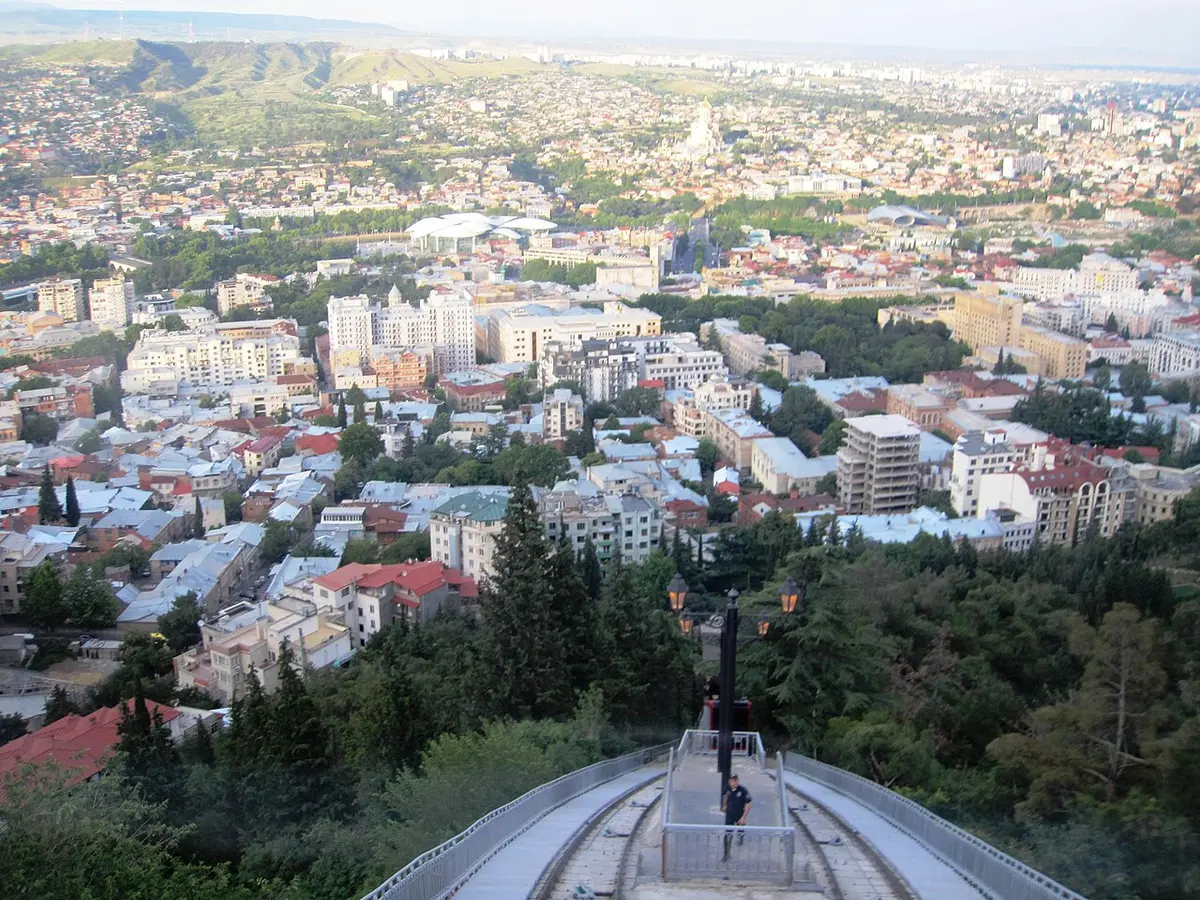 The funicular track running steeply down Mtatsminda, with the city spread out below