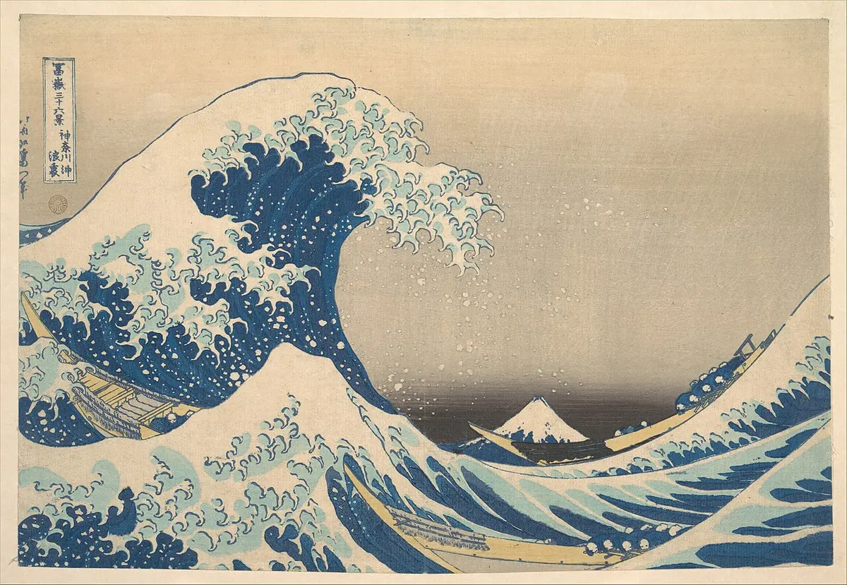 Hokusai print of a great wave curling over three boats, with Mount Fuji small in the distance
