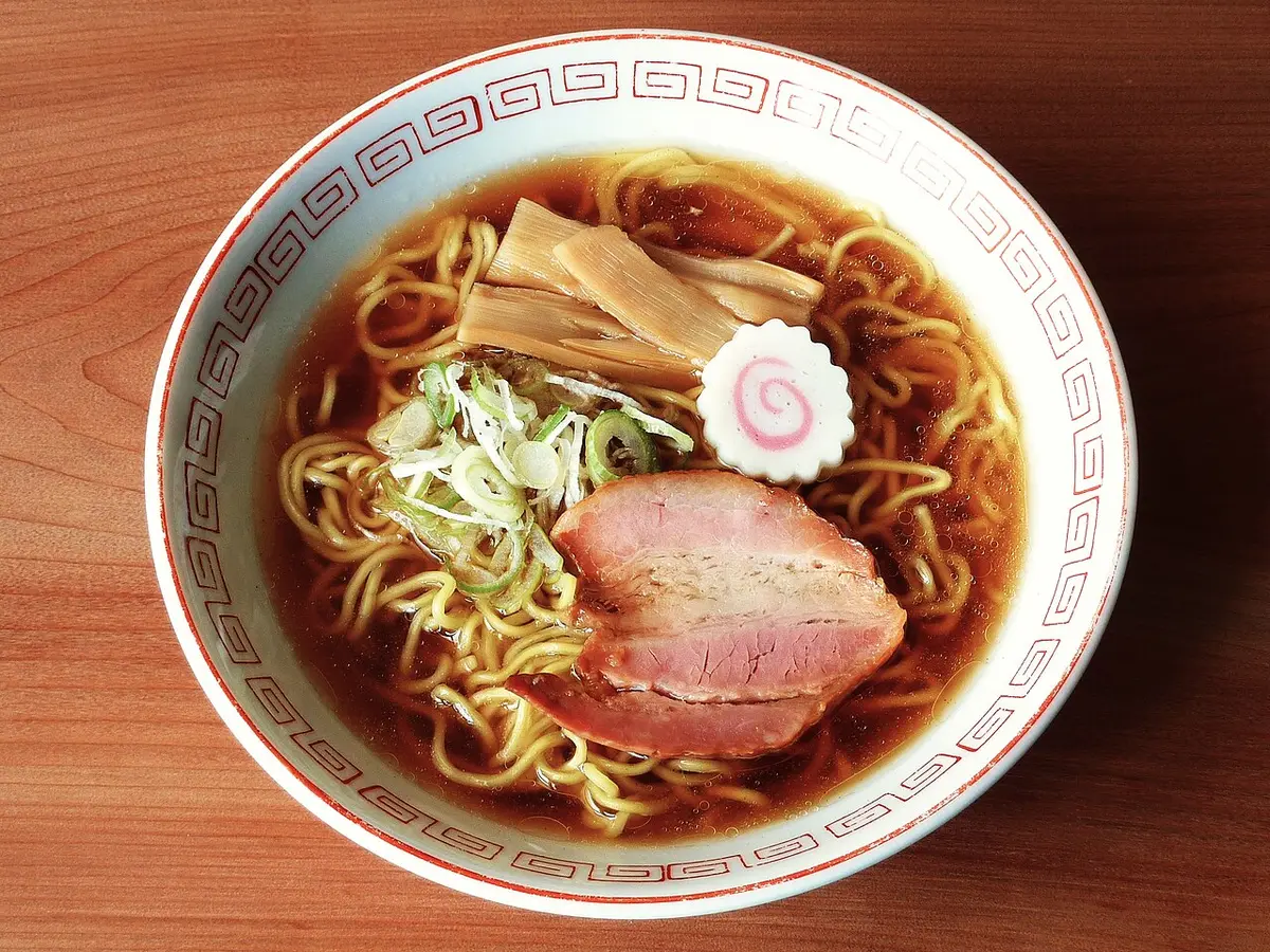 A bowl of Tokyo shōyu ramen with sliced pork, bamboo shoots and a slice of fish cake