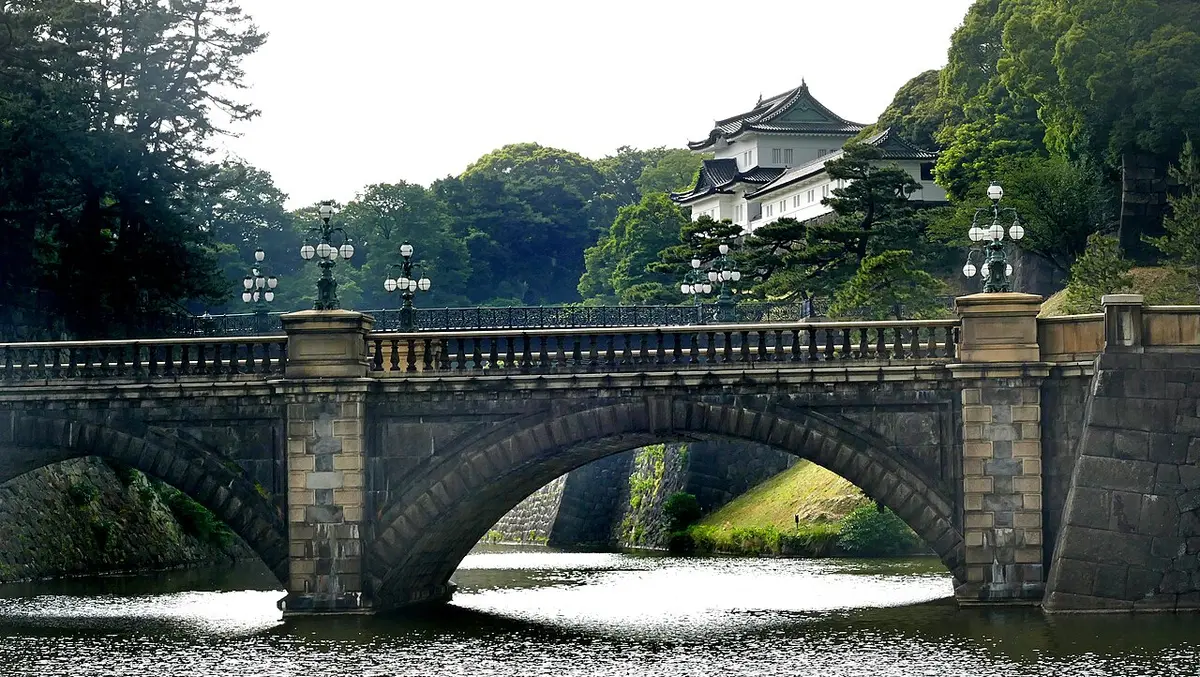 The double-arched stone bridge in front of the Imperial Palace, with the white Fushimi turret behind it