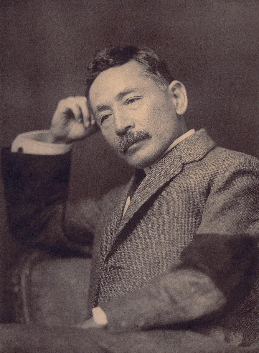 Photograph of Natsume Sōseki in a tweed jacket, his head resting on one hand