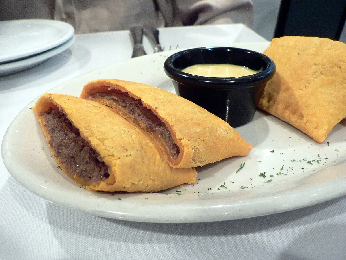 Jamaican beef patties cut open on a plate to show the spiced filling