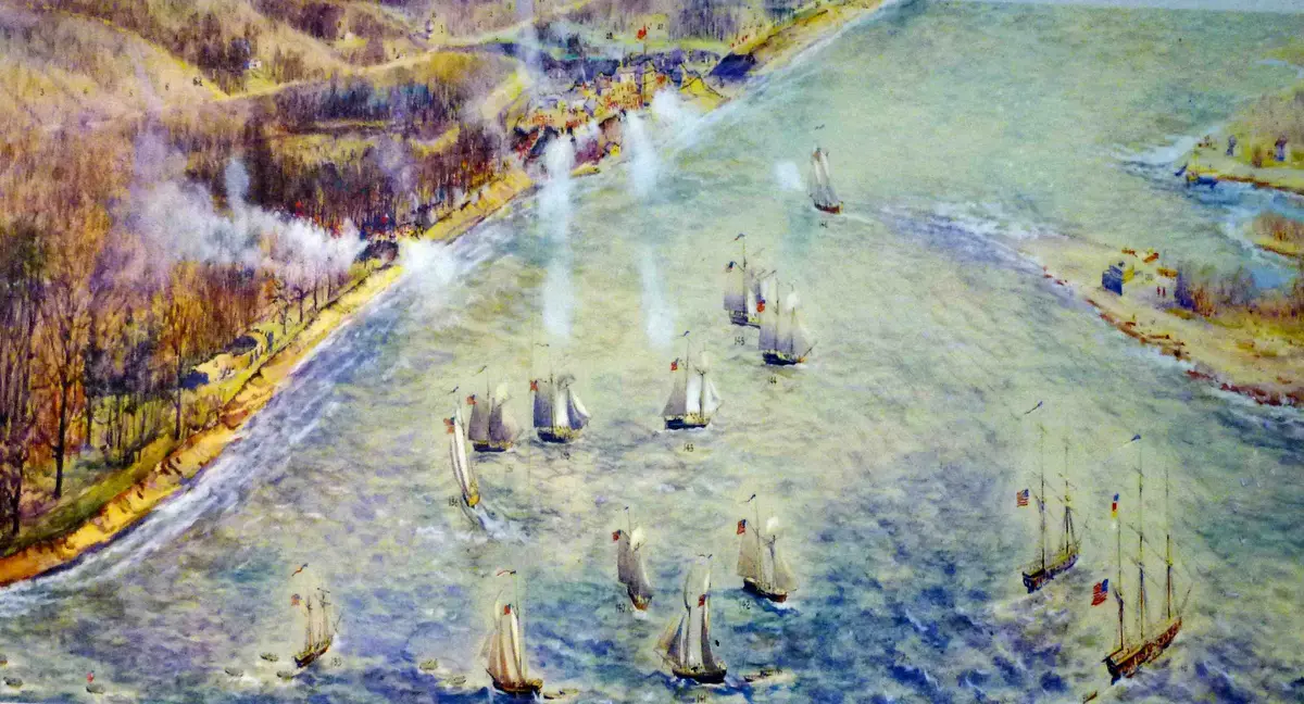 Painting of American sailing ships firing on a wooded shore, smoke rising, the small town of York beyond