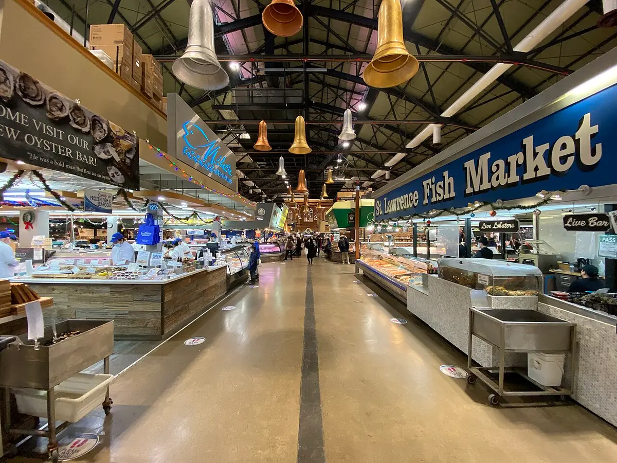 Stalls and hanging lamps along an aisle of the St. Lawrence Market South building