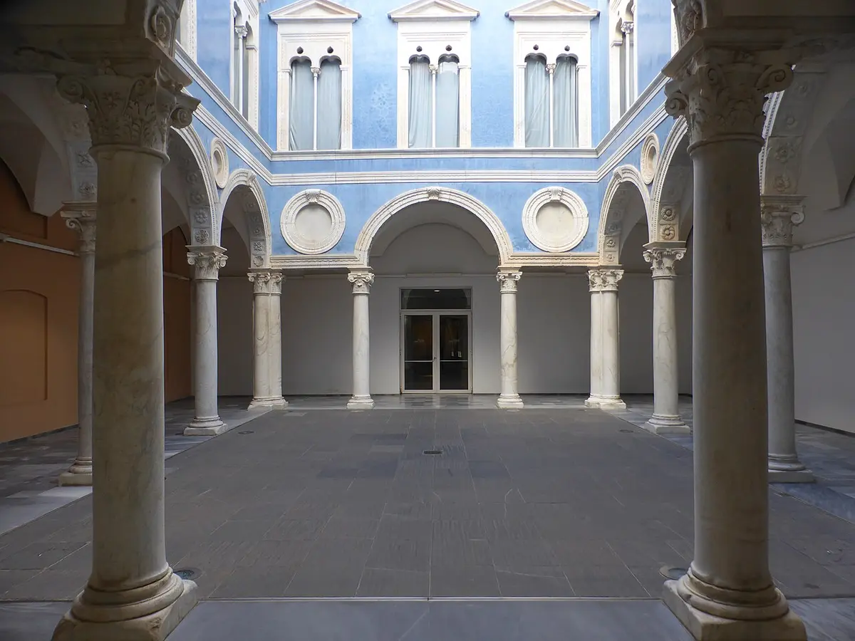 A Renaissance courtyard of marble columns and arches inside the Fine Arts Museum